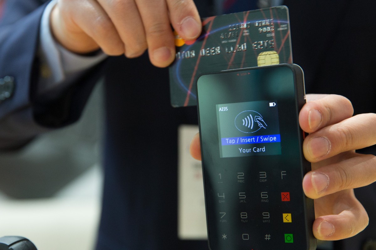 Credit card being swiped on a mobile card reader