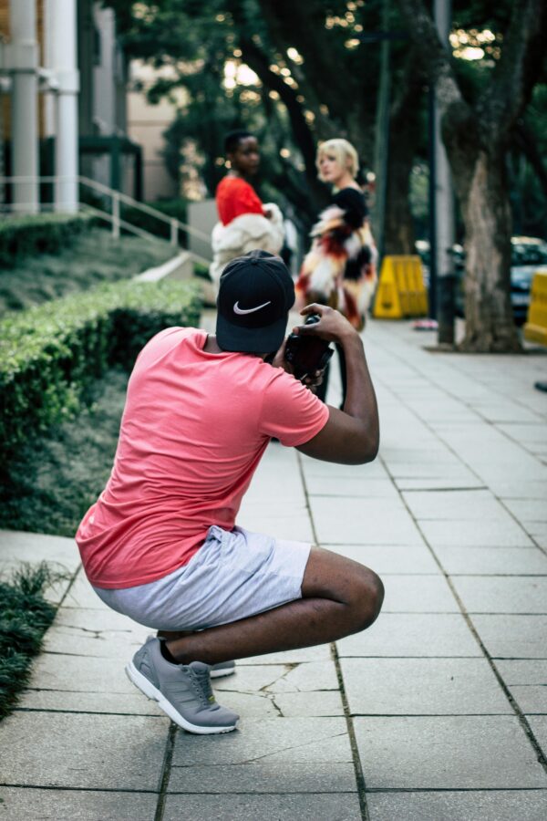 A man shoots a candid photo of two friends
