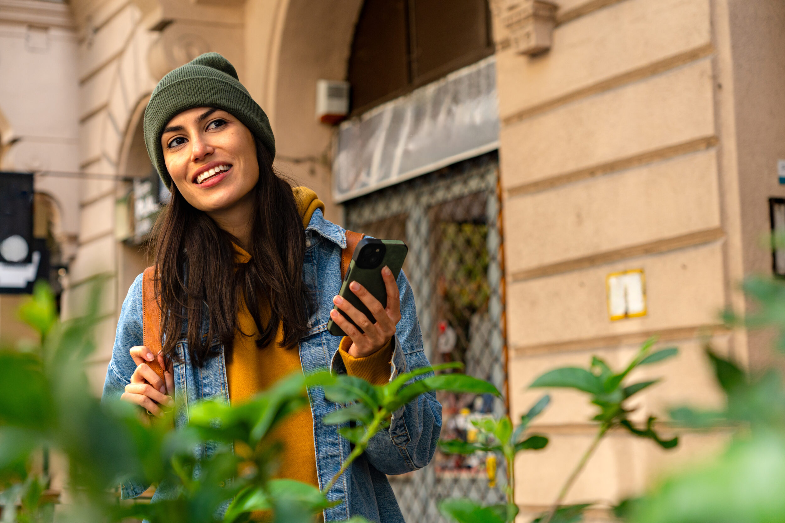 A young woman exploring the city, using her phone to discover new places