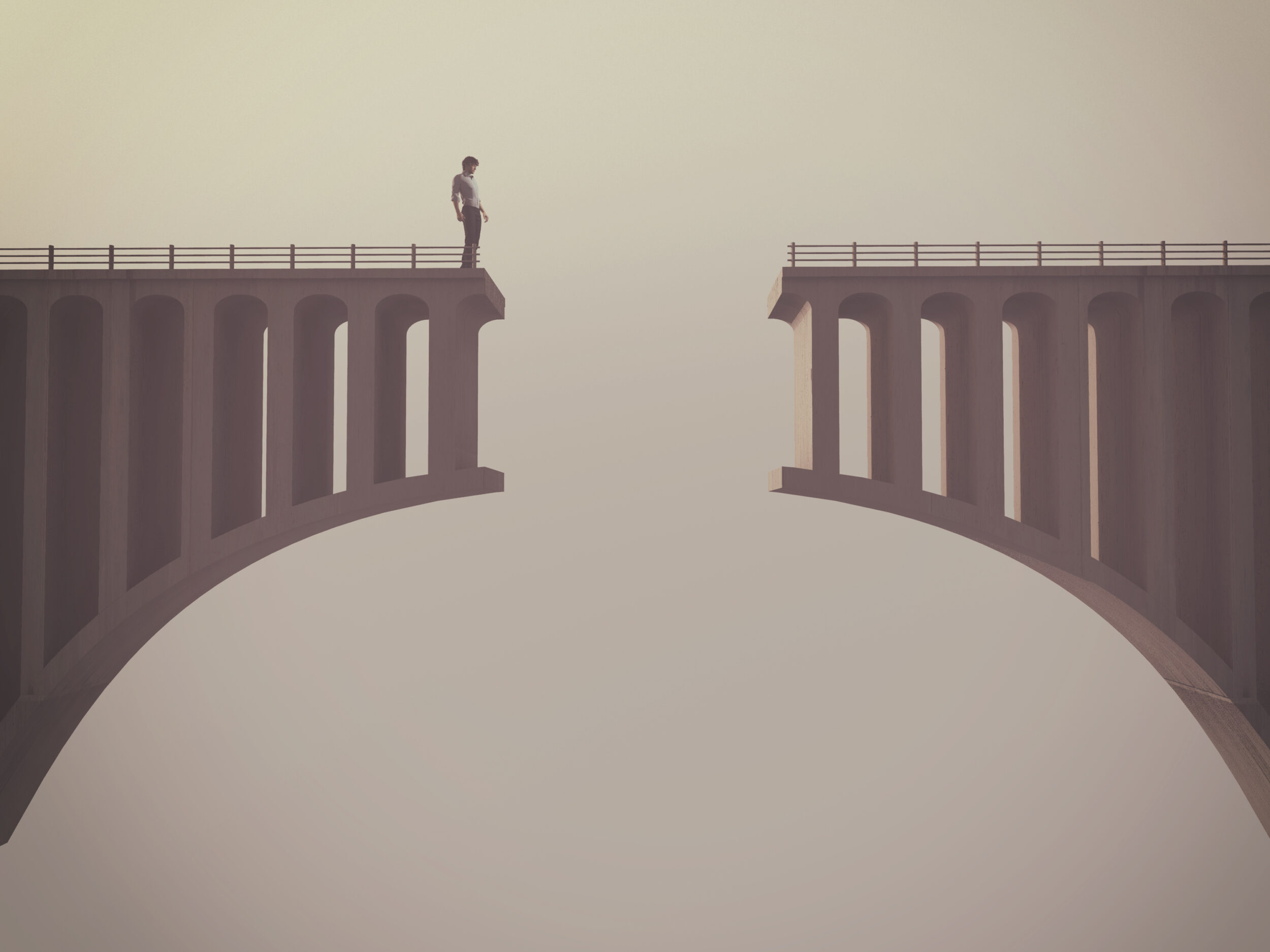 Man in front of a broken bridge